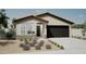Charming single-story home with a well-manicured front yard and a two-car garage at 18066 W Sand Hills Dr, Surprise, AZ 85387