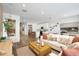 Bright and open living room with hardwood floors and a view into the modern kitchen at 18066 W Sand Hills Dr, Surprise, AZ 85387