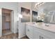 Elegant bathroom featuring double vanities, modern fixtures, and a walk-in shower at 18072 W Sand Hills Dr, Surprise, AZ 85387