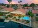 Aerial view of a home with a pool, patio, and waterway with lush landscaping at 186 N Starboard Dr, Gilbert, AZ 85234