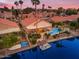 Stunning aerial view of a waterfront property with a pool, boat dock, and desert landscaping at 186 N Starboard Dr, Gilbert, AZ 85234