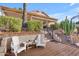 Charming backyard featuring lush landscaping, a tiered wooden deck with outdoor seating, and a home exterior at 186 N Starboard Dr, Gilbert, AZ 85234