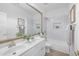 Well-lit bathroom with double sinks, a full mirror, and tiled shower at 186 N Starboard Dr, Gilbert, AZ 85234