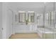 Bright bathroom with dual vanities, framed mirrors, a soaking tub, and a separate glass-enclosed shower at 186 N Starboard Dr, Gilbert, AZ 85234