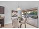 Cozy dining area with a round table, four chairs, stylish light fixture, and a view of the backyard pool at 186 N Starboard Dr, Gilbert, AZ 85234