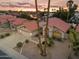 Beautiful desert home featuring a red tile roof, large driveway, and lush landscaping set against a scenic sunset backdrop at 186 N Starboard Dr, Gilbert, AZ 85234