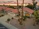 Charming home with a three-car garage, desert landscaping, and a red tile roof at sunset at 186 N Starboard Dr, Gilbert, AZ 85234