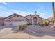 Charming home with a three-car garage, stone accents, and low-maintenance desert landscaping at 186 N Starboard Dr, Gilbert, AZ 85234