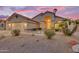 Charming home featuring a three-car garage, stone accents, and low-maintenance desert landscaping at 186 N Starboard Dr, Gilbert, AZ 85234