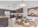 Open-concept kitchen and dining area featuring stainless steel appliances, granite countertops, and seating at 186 N Starboard Dr, Gilbert, AZ 85234