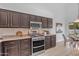 Updated kitchen with stainless steel appliances, granite counters, and dark cabinets at 186 N Starboard Dr, Gilbert, AZ 85234