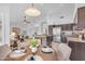 Bright and airy kitchen featuring stainless steel appliances, and an adjacent dining space with hardwood floors throughout at 186 N Starboard Dr, Gilbert, AZ 85234