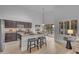 Stylish kitchen featuring dark cabinets, stainless steel appliances, and an island with bar stool seating, plus view of pool at 186 N Starboard Dr, Gilbert, AZ 85234