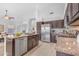 Spacious kitchen featuring an island with bar stools, granite countertops, stainless steel appliances, and dark wood cabinetry at 186 N Starboard Dr, Gilbert, AZ 85234