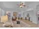 Bright living room features modern decor, comfortable seating, and plenty of natural light with an area rug and ceiling fan at 186 N Starboard Dr, Gilbert, AZ 85234