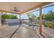 Covered patio overlooking a pool, spa, waterway, and mature landscaping at 186 N Starboard Dr, Gilbert, AZ 85234