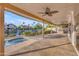 Covered patio area with a fan, built-in grill, and a hot tub overlooking the canal at 186 N Starboard Dr, Gilbert, AZ 85234