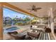 Relaxing covered patio with canal views, comfortable seating, and a built-in hot tub at 186 N Starboard Dr, Gilbert, AZ 85234