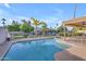 Beautiful pool and spa overlooking a canal with mature landscaping and clear skies at 186 N Starboard Dr, Gilbert, AZ 85234