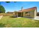 Wide shot of backyard with covered patio and well-maintained lawn at 1918 E Anchor Dr, Gilbert, AZ 85234