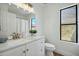 Bright bathroom with a white vanity, a large mirror, and a window allowing for natural light at 1918 E Anchor Dr, Gilbert, AZ 85234