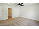 Clean bedroom with carpet, ceiling fan, and a view into a bathroom with a shower/tub combination at 1918 E Anchor Dr, Gilbert, AZ 85234