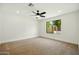 Carpeted bedroom is spacious with natural light from backyard window and modern ceiling fan at 1918 E Anchor Dr, Gilbert, AZ 85234