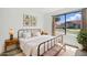 Cozy bedroom featuring a wrought iron bed frame, complementing side tables and a view to the outside at 1918 E Anchor Dr, Gilbert, AZ 85234