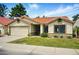 Beautiful single-story home with terracotta tile roof, green lawn, and an attached garage at 1918 E Anchor Dr, Gilbert, AZ 85234