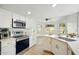 Bright, updated kitchen featuring white cabinets, stainless appliances, and bar sink at 1918 E Anchor Dr, Gilbert, AZ 85234