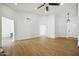 Empty living room with light wood floors, white walls, and ceiling fan at 1918 E Anchor Dr, Gilbert, AZ 85234