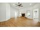 Spacious living room with wood floors, fireplace, ceiling fan, and large windows at 1918 E Anchor Dr, Gilbert, AZ 85234