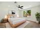 This main bedroom has neutral tones, a ceiling fan, and a light wood bed frame and side tables at 1918 E Anchor Dr, Gilbert, AZ 85234