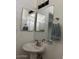 Bathroom with large mirrors, updated vanity lighting, and a ceramic sink at 19601 N 7Th N St # 1032, Phoenix, AZ 85024