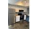 Kitchen boasts stainless steel appliances, sleek white cabinets, and decorative tile flooring at 19601 N 7Th N St # 1032, Phoenix, AZ 85024