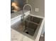 Close-up of a stainless steel kitchen sink with modern fixtures and marble countertops at 19601 N 7Th N St # 1032, Phoenix, AZ 85024