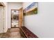 Inviting foyer featuring a bench, tile flooring, and art adding a touch of warmth to the entry at 20183 N Big Dipper Dr, Maricopa, AZ 85138