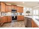 Modern kitchen with stainless steel appliances, granite countertops, and tile backsplash for easy upkeep at 20183 N Big Dipper Dr, Maricopa, AZ 85138