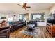 Spacious living room with wood floors, large windows, and comfortable seating, perfect for relaxation at 20183 N Big Dipper Dr, Maricopa, AZ 85138