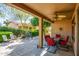 Spacious covered patio with ceiling fan, dining set, and additional seating offers a relaxing retreat at 20183 N Big Dipper Dr, Maricopa, AZ 85138