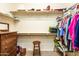 Walk-in closet with shelving, wooden stool, and plenty of room for clothes at 20183 N Big Dipper Dr, Maricopa, AZ 85138