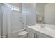 This bathroom features a shower over tub combination, white tiling, and modern vanity at 20373 W Coolidge St, Buckeye, AZ 85396