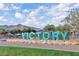 Illuminated 'VICTORY' community sign on a stone base with manicured landscaping and mountain backdrop at 20373 W Coolidge St, Buckeye, AZ 85396