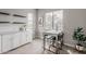 This dining area includes a small table, white cabinetry, and natural light at 20373 W Coolidge St, Buckeye, AZ 85396