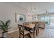 Open dining area with a wood table, backyard views, pendant lighting and access to the living room at 20373 W Coolidge St, Buckeye, AZ 85396