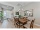 Dining room with a wooden table, six chairs, modern chandelier, and a large decorative mirror at 20373 W Coolidge St, Buckeye, AZ 85396