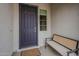 Inviting front entrance with a cozy bench, stylish door, and a welcoming mat, creating a warm first impression at 20373 W Coolidge St, Buckeye, AZ 85396