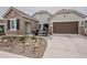 Charming home exterior with a well-manicured desert-style landscape and a convenient golf cart parked in front of the garage at 20373 W Coolidge St, Buckeye, AZ 85396
