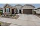 Beautiful home exterior with desert landscaping, a spacious driveway, and a charming facade, showcasing its curb appeal at 20373 W Coolidge St, Buckeye, AZ 85396