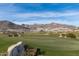 Scenic golf course surrounded by desert landscape and mountain views on a sunny day at 20373 W Coolidge St, Buckeye, AZ 85396